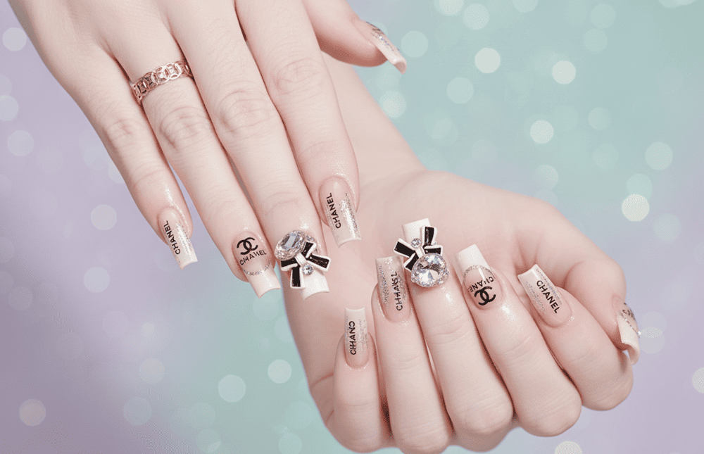 Mẫu nail vuông thang trong suốt đính nơ và logo Chanel thời thượng