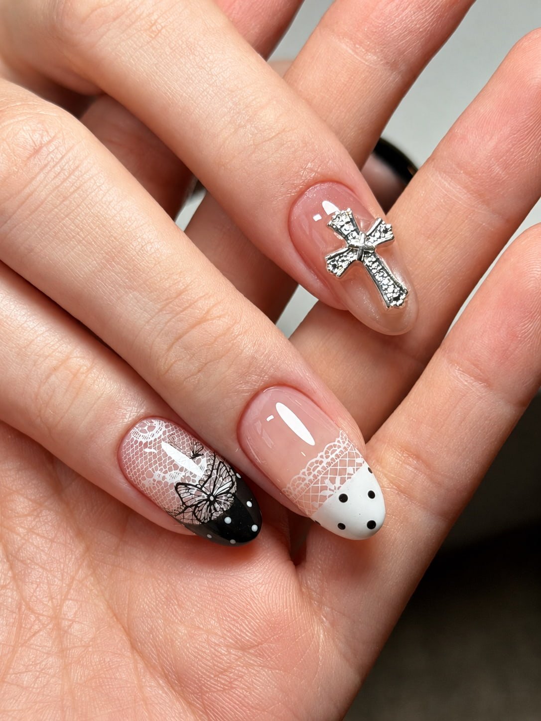 Black and White French Nails with Lace, Butterfly, and Cross Charm Art