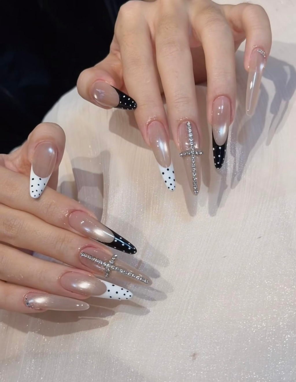 Black and White French Nails with Polka Dots and Rhinestone Cross Charms