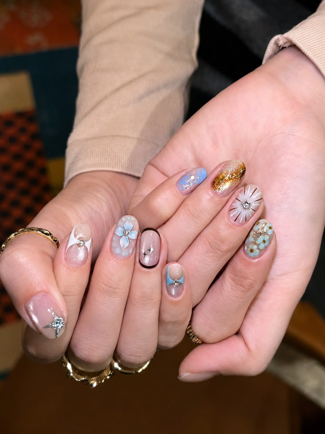 Blue Floral and Gold Glitter Fall Nail Design with Soft Nude Base