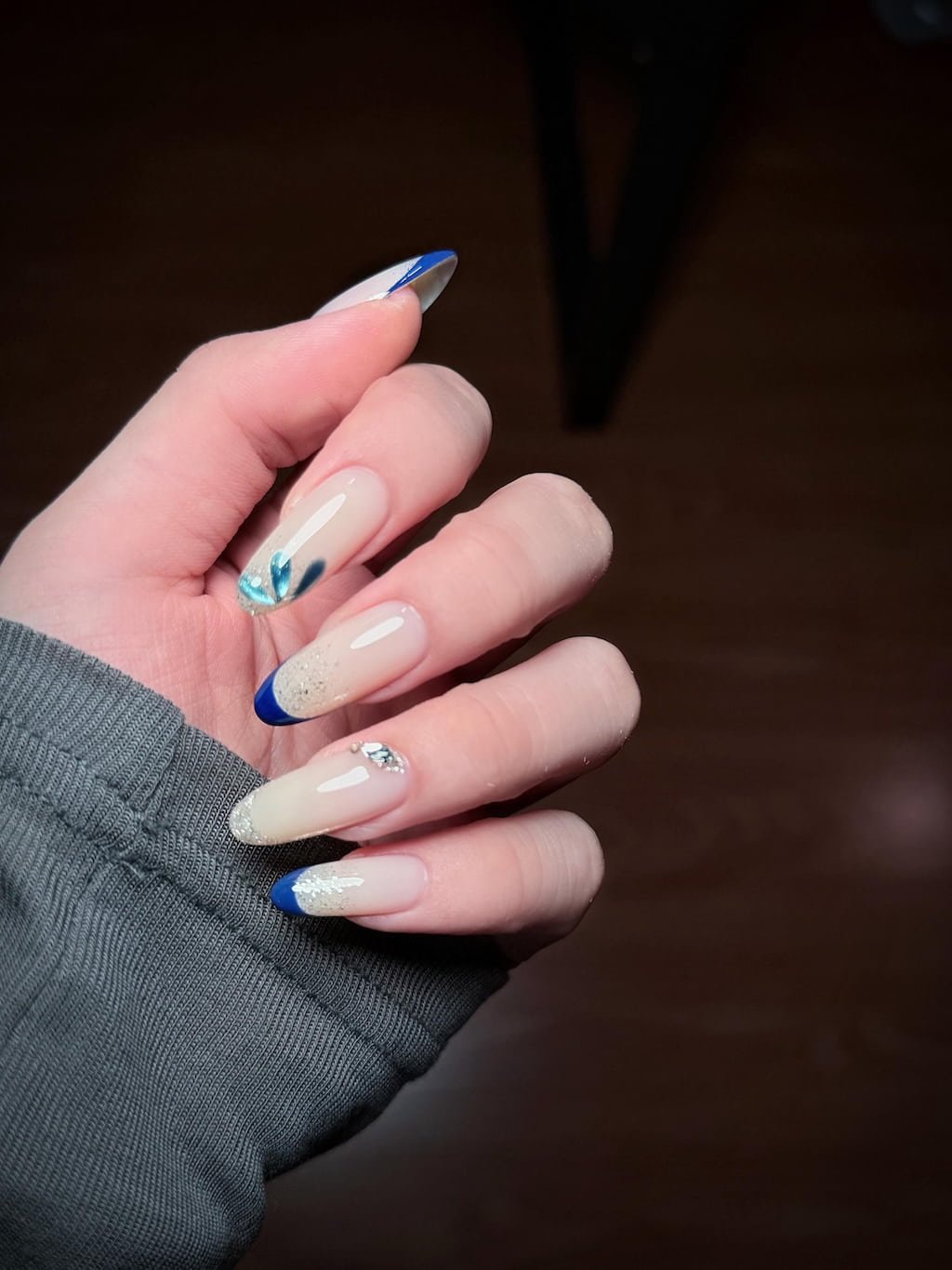 Blue French Nails with Glitter, Crystal, and Floral Details