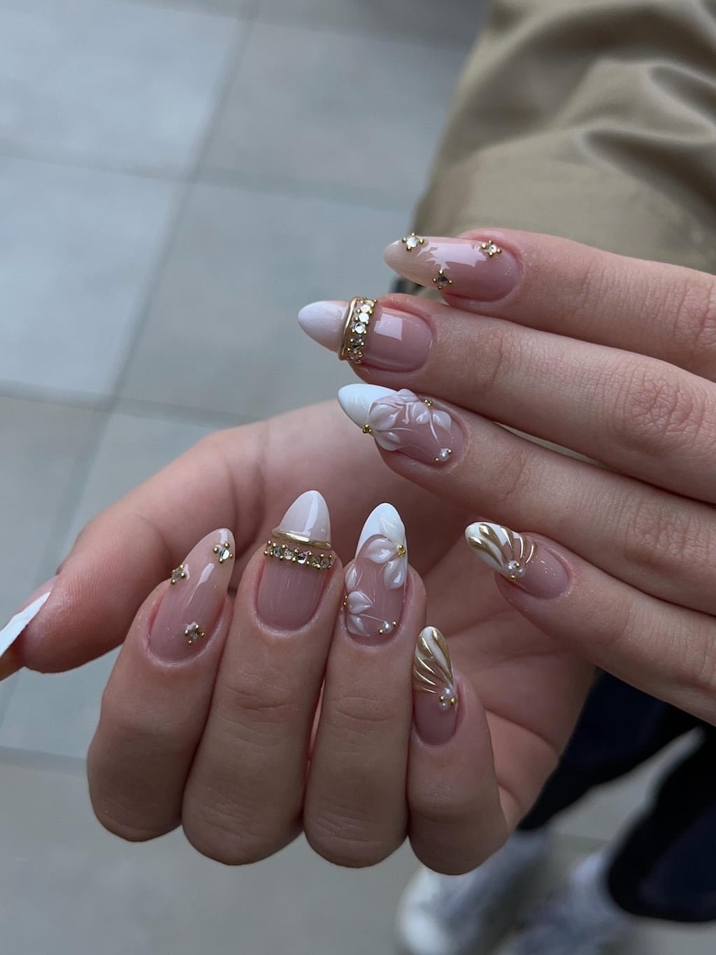 Elegant White Floral Summer Nail Design with Gold Accents