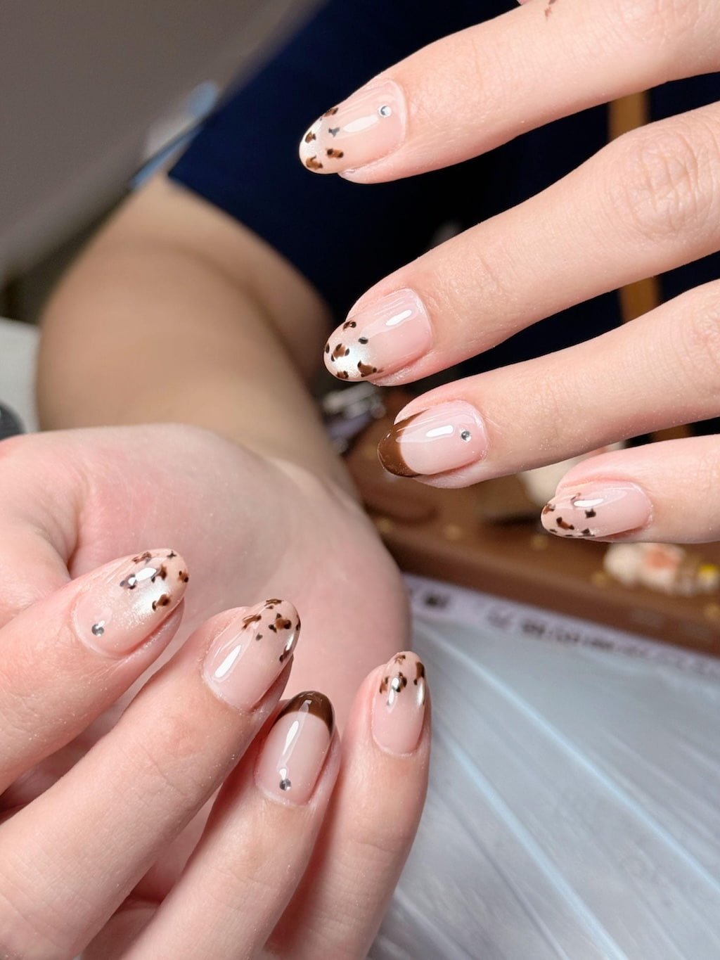 Pink French Nails with White Swirl Tips and Floral Details