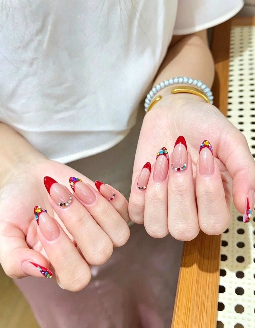 Red French Nails with Colorful Rhinestone Accents