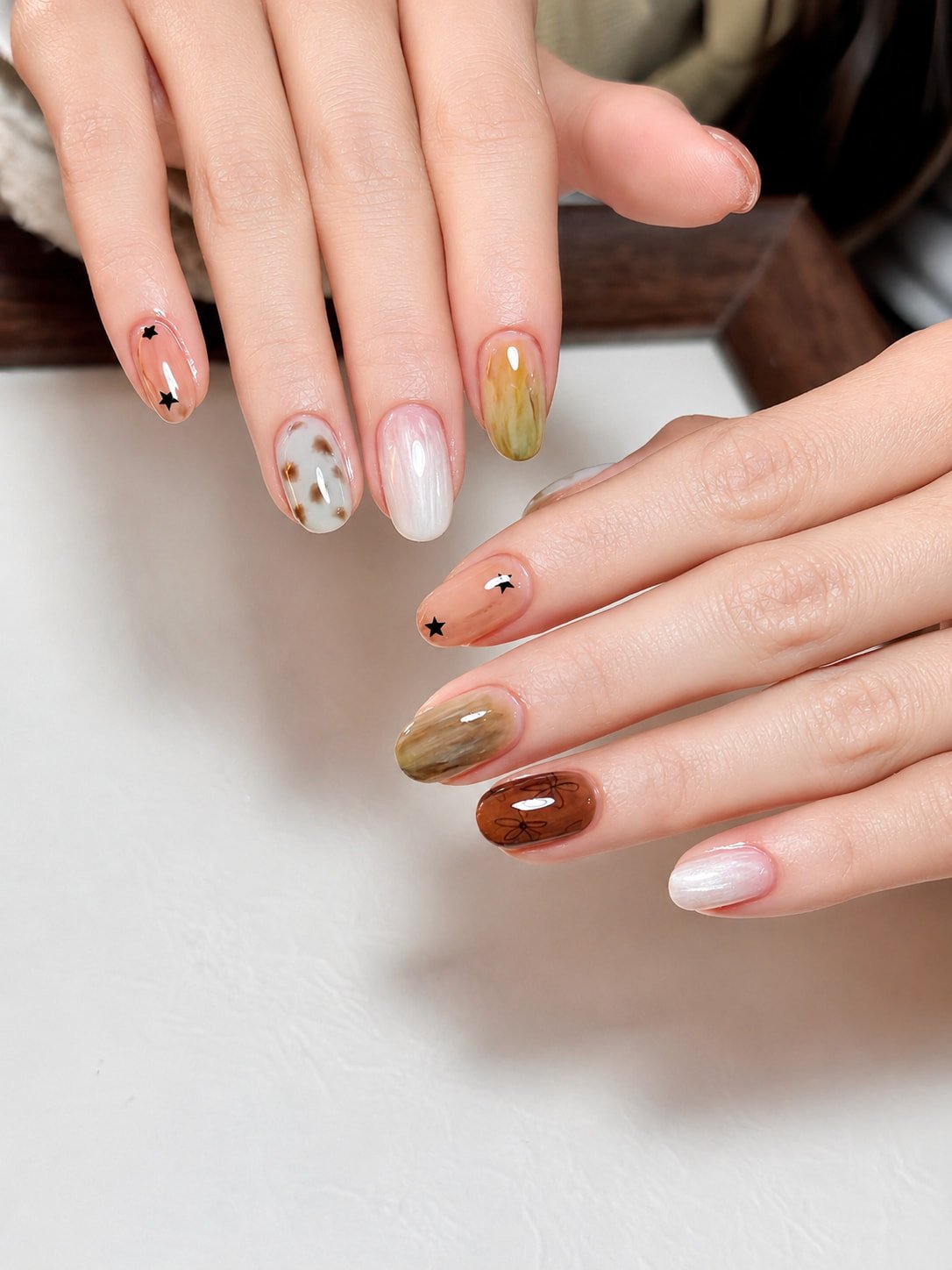 Soft Marble and Star Accent Fall Nail Design for a Natural Look
