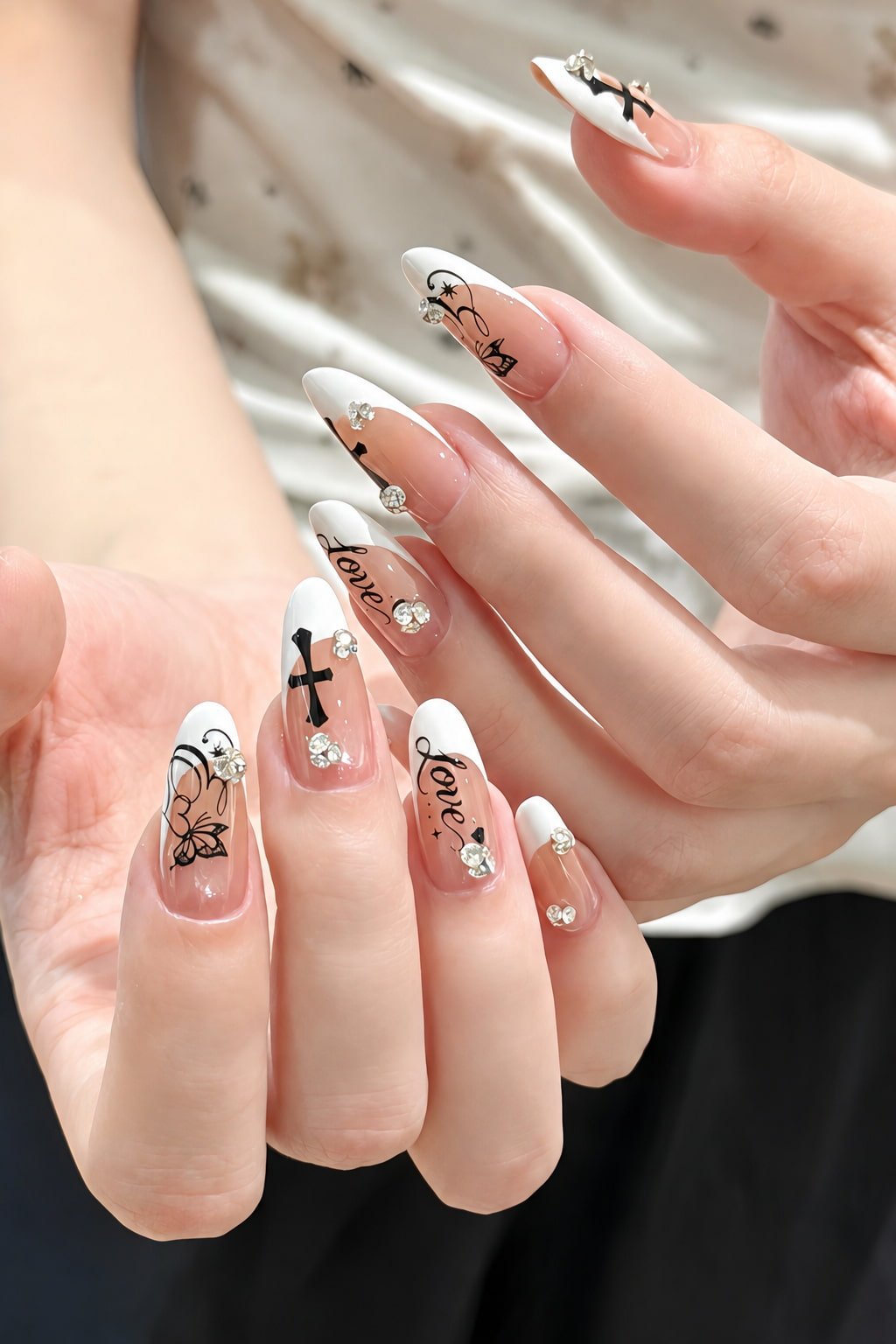 White French Nails with Black Line Art, Crosses, and Crystal Charms