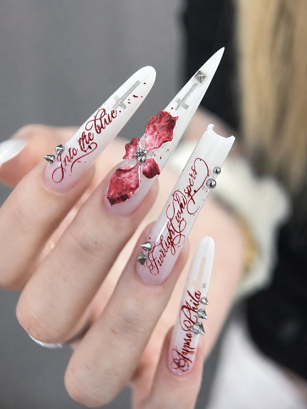 White Stiletto Y2K Nails with Red Script and 3D Bows